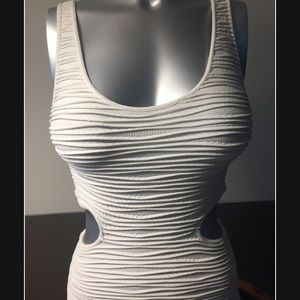 Gently used white bebe dress with side cutouts.